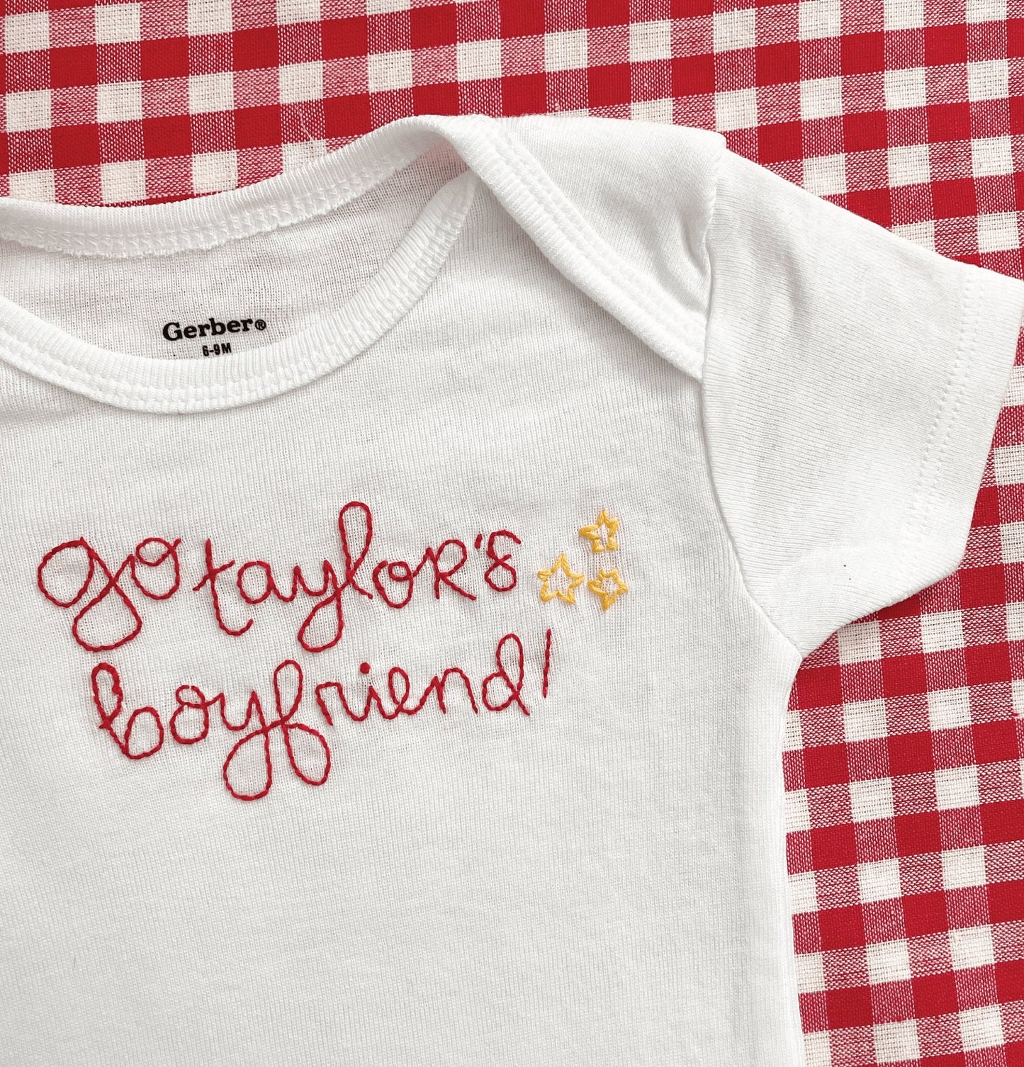 Go Taylor's Boyfriend hand embroidered in red with 3 yellow stars on the right of the text