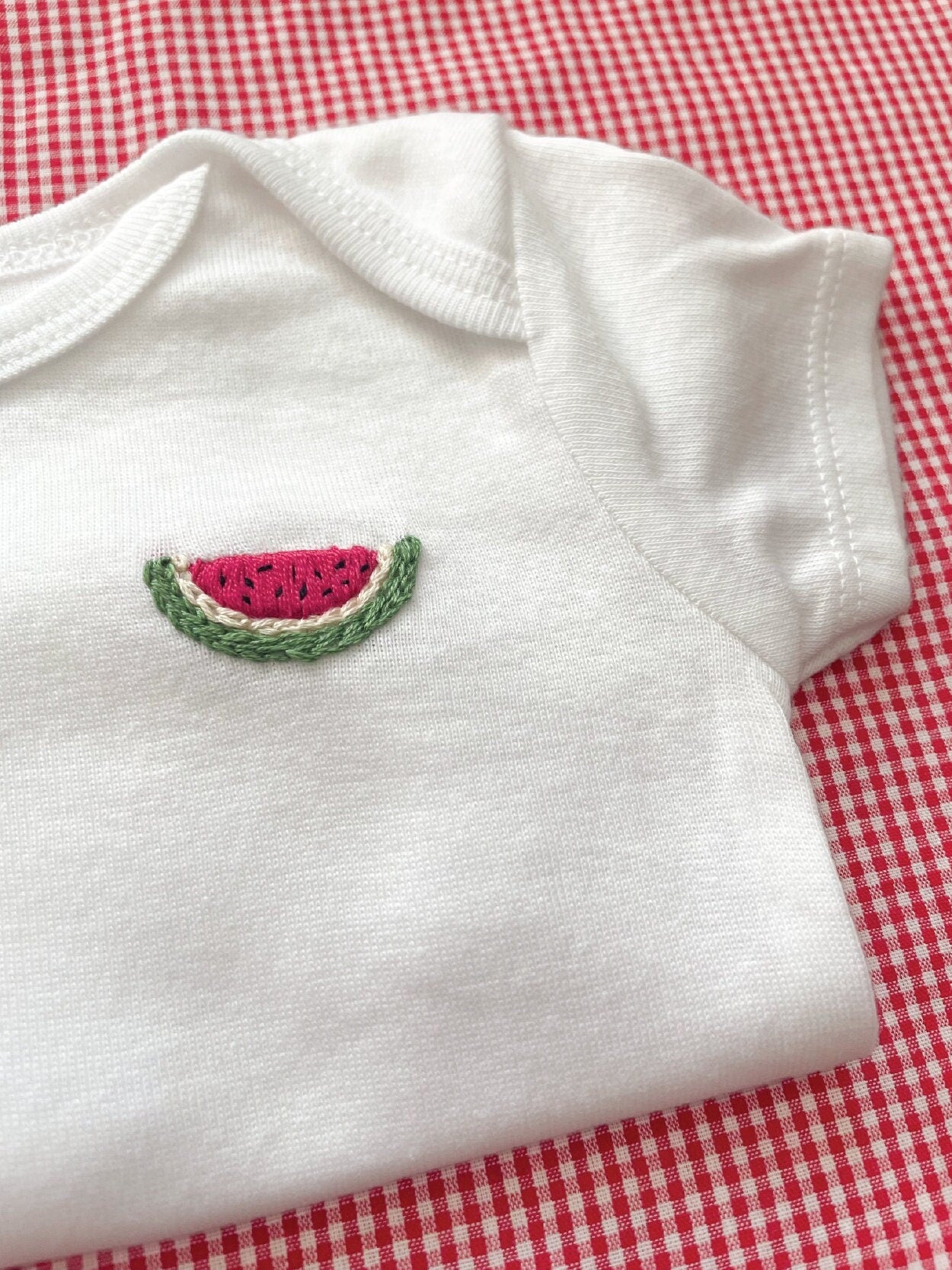 Watermelon hand embroidery on white baby onesie