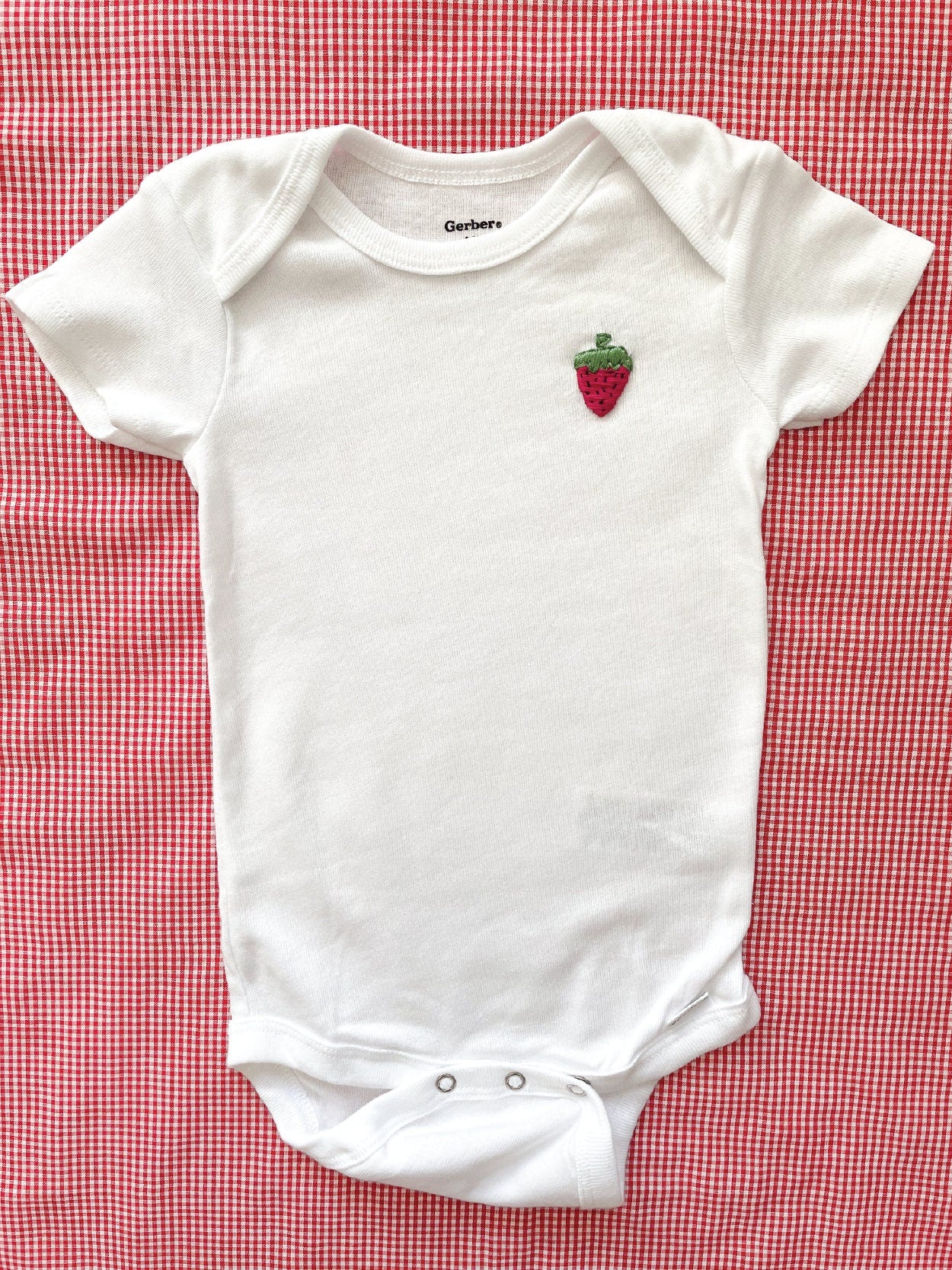 strawberry hand embroidery on white baby onesie