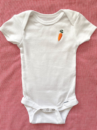 carrot hand embroidery on white baby onesie