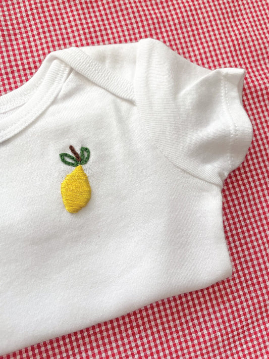 Lemon hand embroidery on white baby onesie