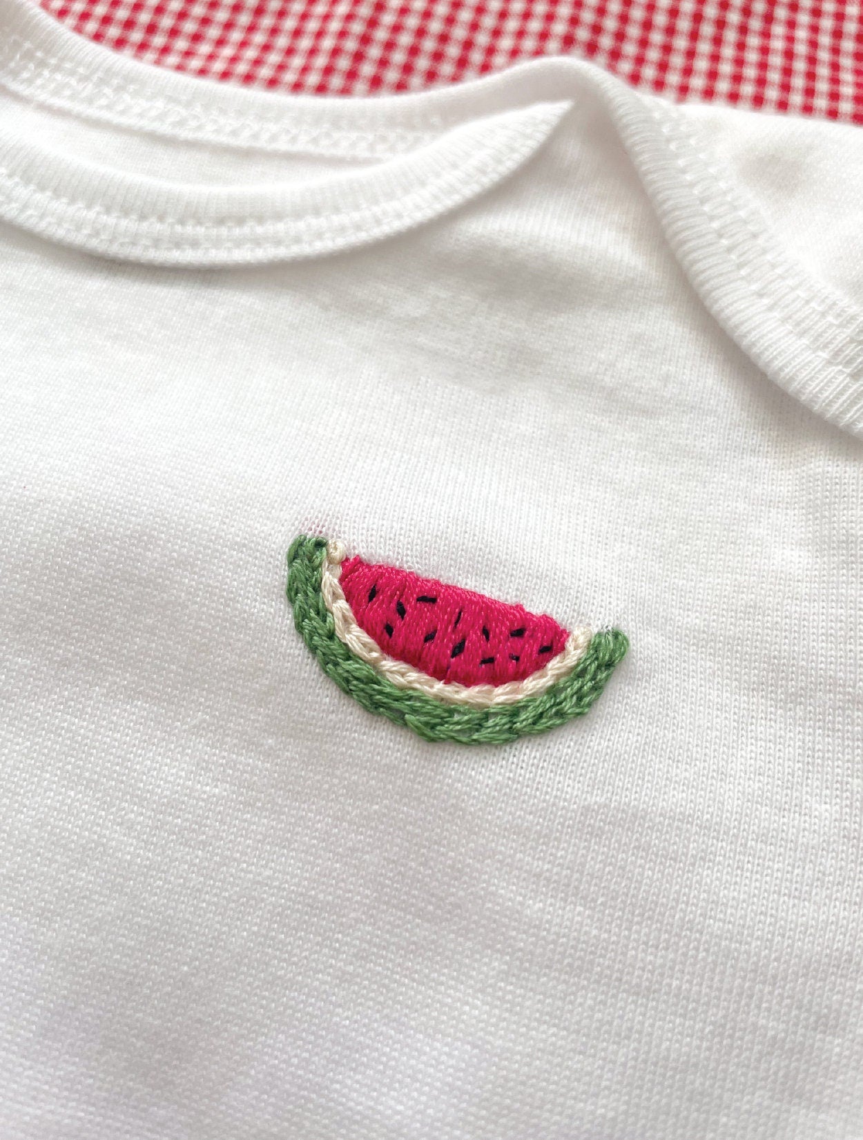 Watermelon hand embroidery on white baby onesie